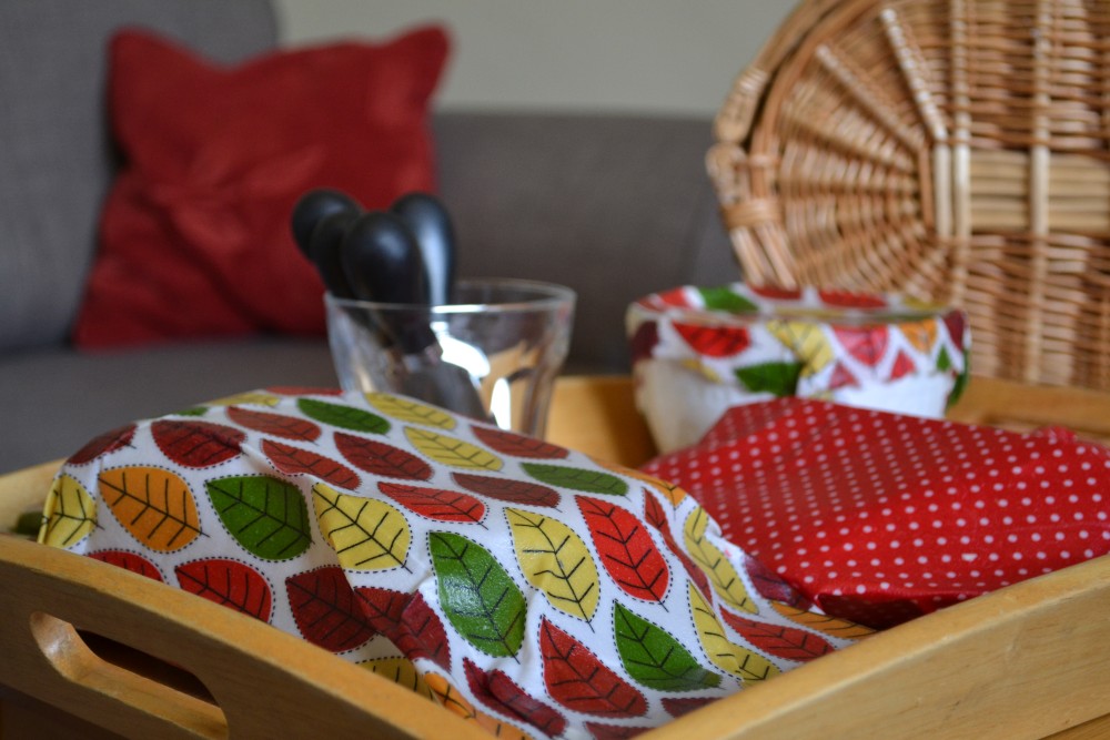 A tray of picnic items which are covered with beeswax wraps